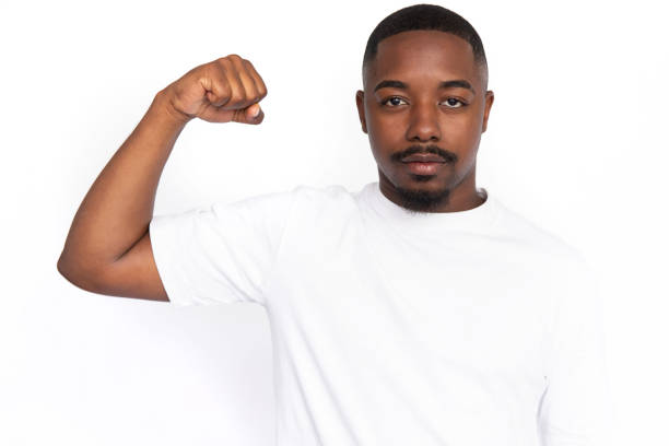 istock Confident young man showing his arm muscle 1455497393