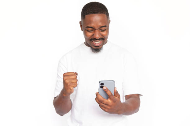 istock Satisfied young man looking at smartphone screen 1455497962