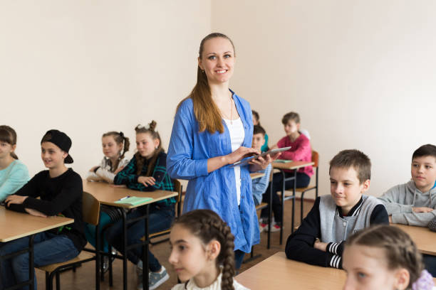 istock Pretty teacher smiling at camera. 1455498414