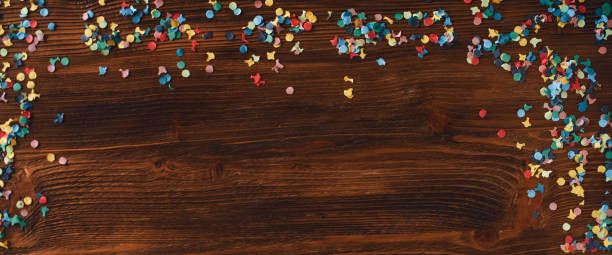 istock Colorful confetti on rustic wood 1455499470