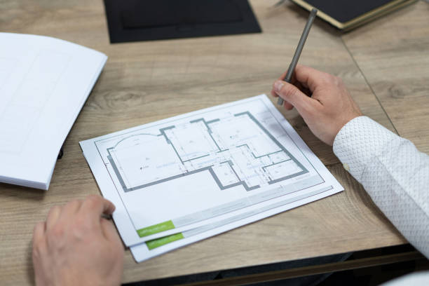 istock construction project drawings are discussed by construction company employees. 1455500318