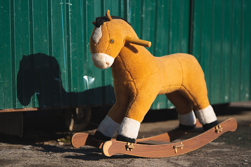 Children's toy wooden horse left alone on the street