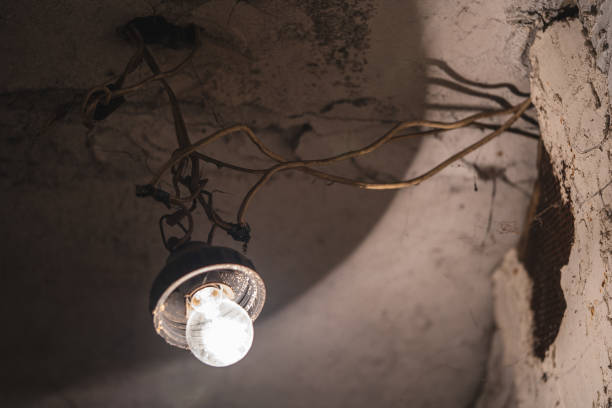 istock an old light bulb hangs on a wire in the basement 1455500426