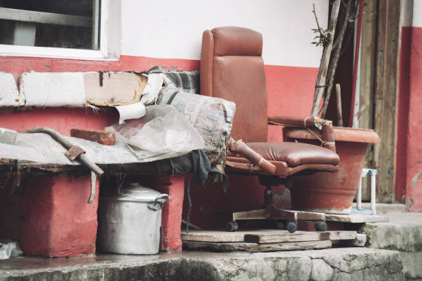 an old broken chair outside and other junk