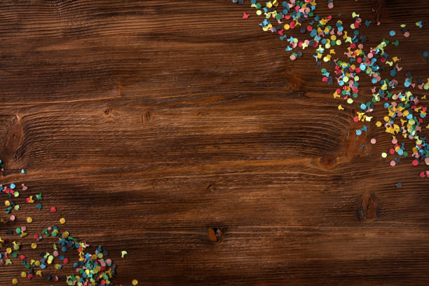 istock Colorful confetti on rustic wood 1455501626