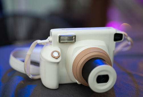 a modern fashionable film camera that takes instant photos
