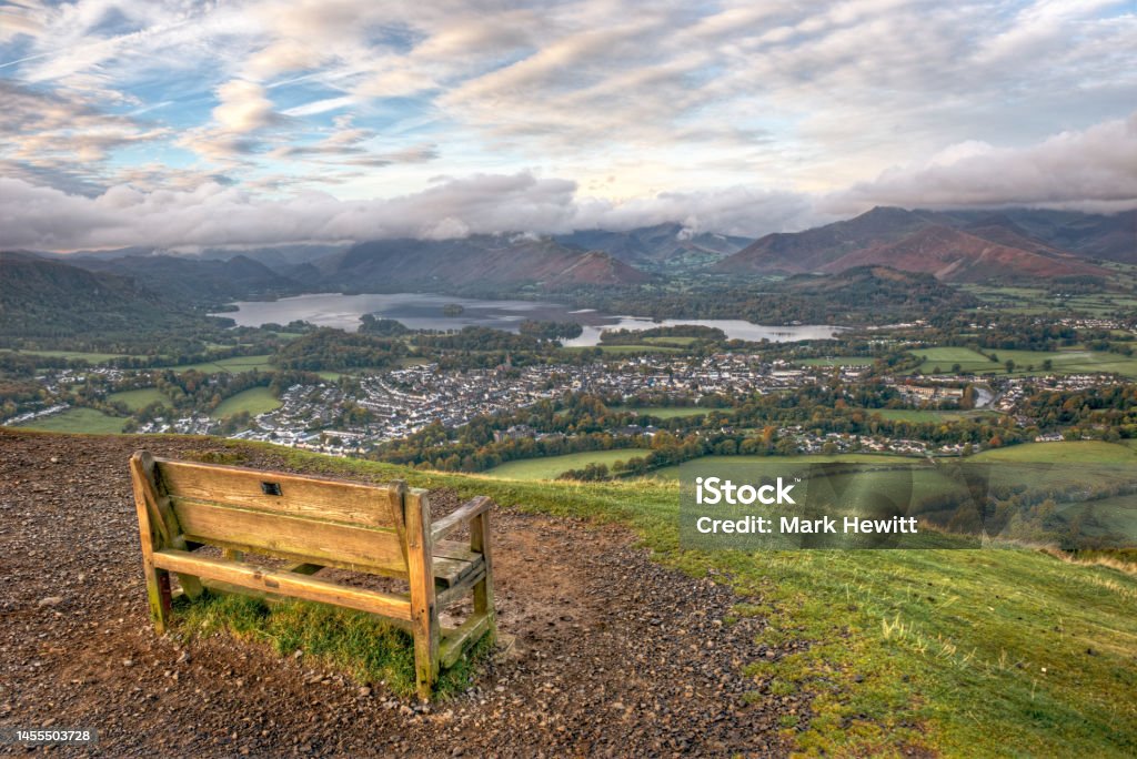 The Early Morning View From Latrigg Bench A great place to take a break - the bench at Latrigg overlooking Keswick, Derwentwater, Walla Crag, Borrowdale, High Spy, Maiden Moor, Catbells, Newlands Valley and Causey Pike, taken not long after sunrise. Bench Stock Photo