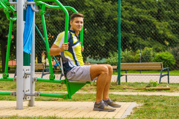 istock Man flexing arm in outdoor gym 1455503831