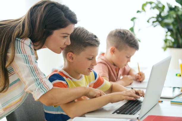 istock Mother helping her sons to do their homework. 1455504201