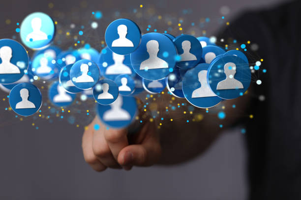 istock Shallow focus of a human hand pointing on human icons, team networking concept 1455505201