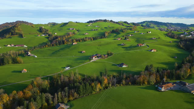 Aerial slide left of Appenzell green hill in Switzerland