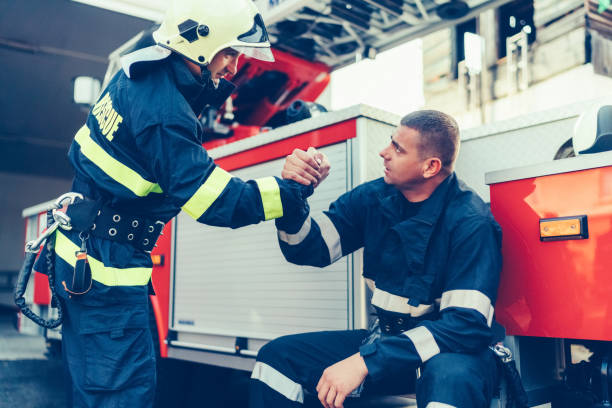 istock Firefighter supporting colleague after a hard day 1455505653