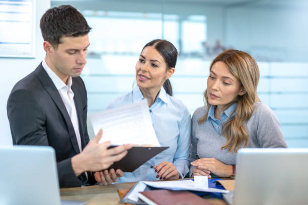 istock Young business partners discussing documents and ideas at meeting in office 1455506116