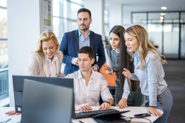 istock Group of business people working together on computer in office 1455507045