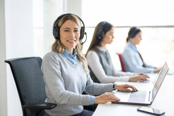 istock Happy smiling customer service operator woman working on laptop computer in call center office 1455507264
