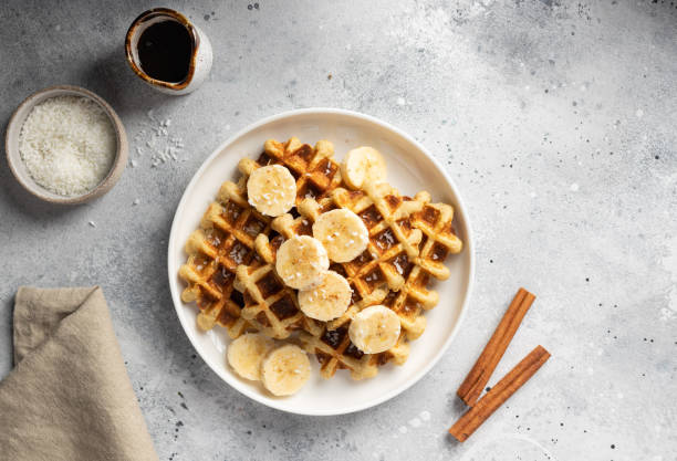 istock Breakfast waffles with bananas, cinnamon, coconut and date syrup 1455507324