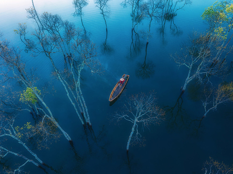 Drone view fisherman in Tuyen Lam lake in a foggy morning, Da Lat city, Lam Dong province, central high lands Vietnam