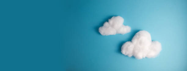 istock Pattern of white fluffy clouds made of cotton wool on a blue background 1455509125