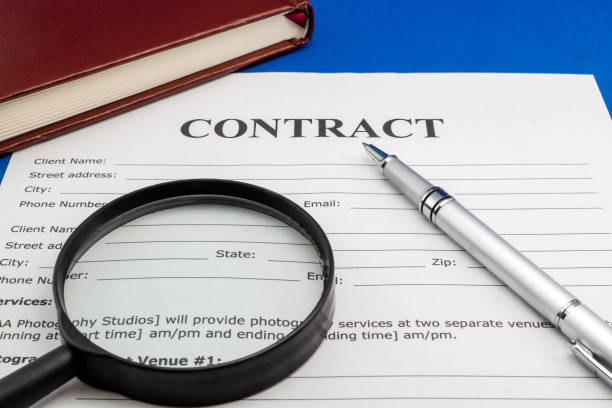 istock Magnifying glass and document contract close up 1455509411
