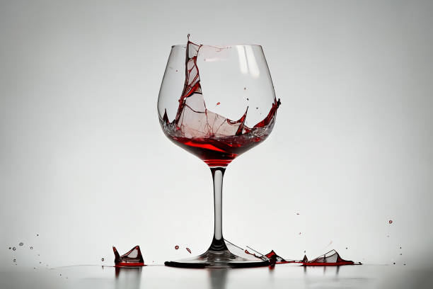 istock Broken red wine glass with pieces and wine spilling, 3d render 1455512073