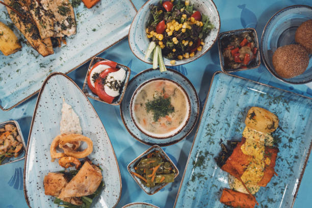 Top view of different dishes, salads and appetizers on the table