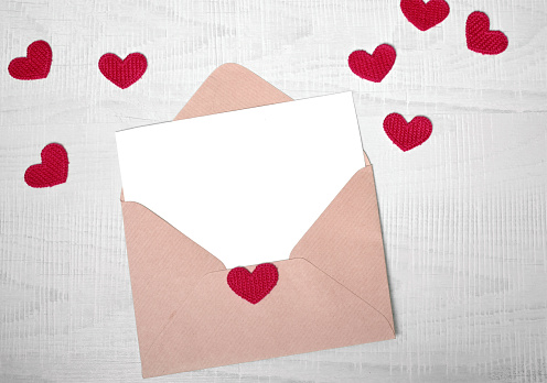 Envelope and pink hearts on white background. Valentine's day, love, anniversary concept.