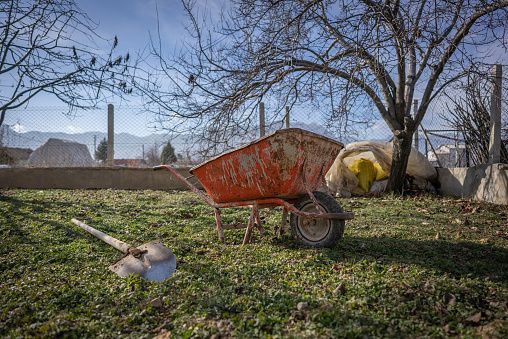 Shovel and the cart on a garden site