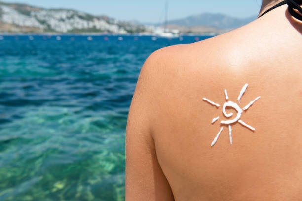 Sun Cream on a Woman's back stock photo