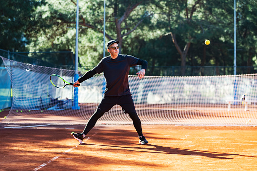 Young adult man playing tennis tennis