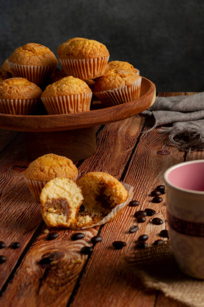 istock Coffee cup and muffins on a wooden table 1455526979