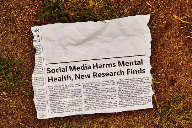 newspaper clipping with headline and article about social media harming mental health, with space for your copy, lying in the dirt - harming imagens e fotografias de stock