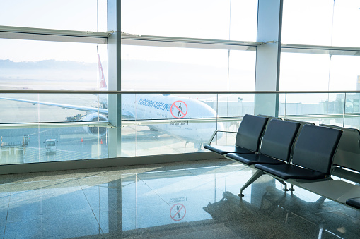 Izmir, Turkey - January 2, 2023: Airport passenger lounge and passengers waiting in Izmir Adnan Menderes Airport.
