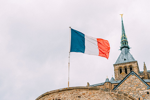 French Flag flying on an Overcast Day at Mont Saint-Michel in the Summer with Copy Space