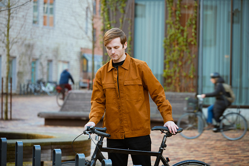 Commuting on bike. Young man using bicycle for transport