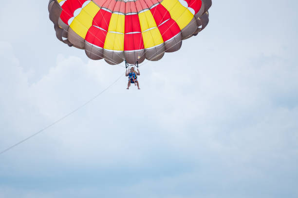 istock Father and son parasailing during summer day at sea 1455530723