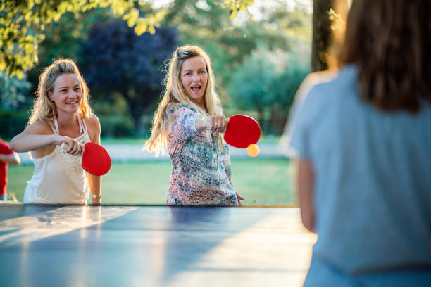 istock Women playing table tennis on summer day 1455530989