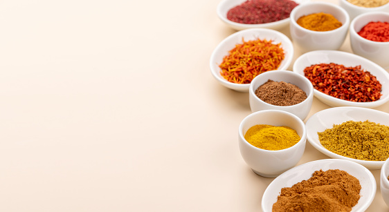 Various dried spices in small bowls with copy space