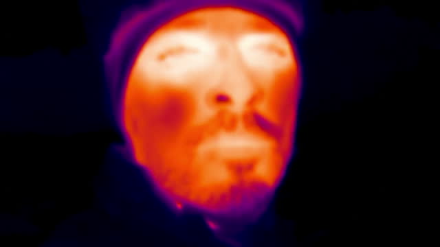 Close up portrait of cyclist in the forest, thermal vision view