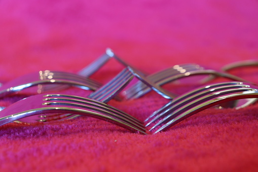 Close up of forks on red