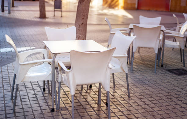 istock white plastic table surrounded by chairs on the terrace of a small cafe 1455531866