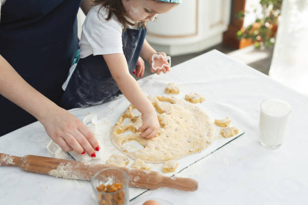 istock child makes cookies from dough on the table on a white background. 1455533318