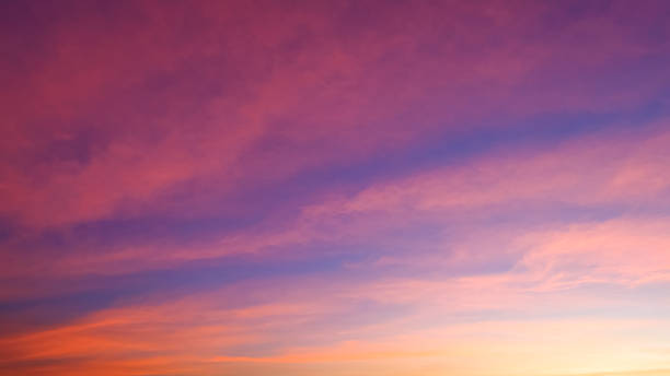 istock Beautiful romantic orange sunset clouds with yellow sunlight on dusk sky twilight background 1455533526