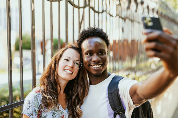 istock Millennials using smart phone outdoors in the city 1455534417