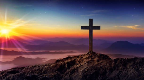 istock Silhouetted christian cross silhouette on the mountain at sunset 1455536633