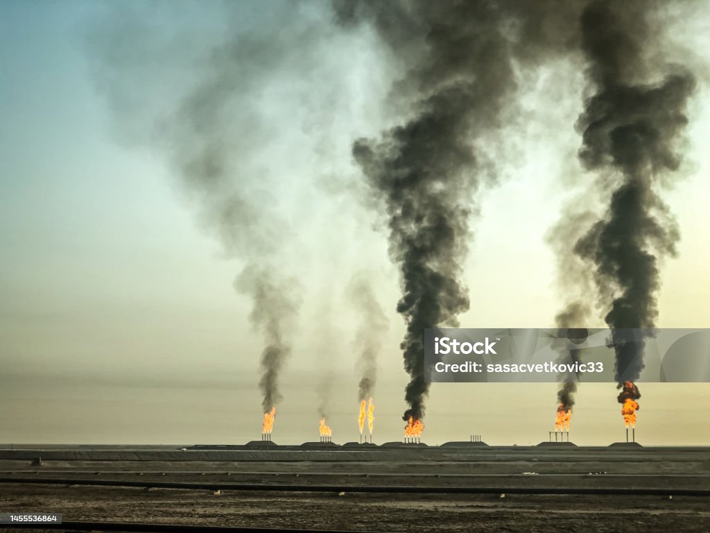 Air pollution, black smoke coming out Oil fields in Iraq, pressure relief system. Oil preparation and pumping workshop Iraq Stock Photo