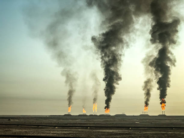 Air pollution, black smoke coming out Oil fields in Iraq, pressure relief system. Oil preparation and pumping workshop oil well stock pictures, royalty-free photos & images