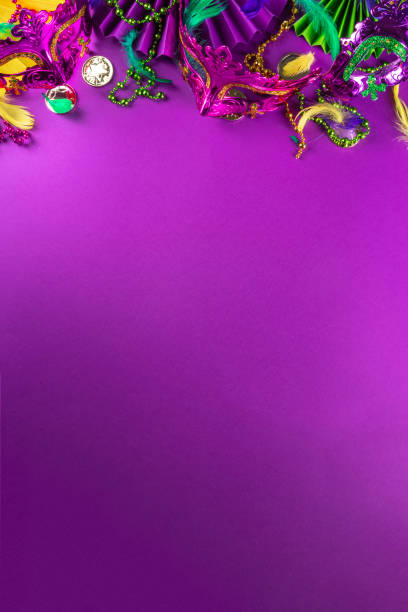 Mardi Gras colorful background Mardi Gras colorful holiday greeting card background with festival masquerade accessories, decor, carnival mask, beads, feathers, fan on bright background traditional yellow purple green colors purple and gold masquerade masks stock pictures, royalty-free photos & images