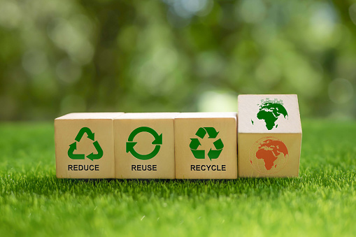 Reused, reduce and recycle concept. Flipping wooden cubes from global warming to enviromental responsibility and protection. Limit global warming and climate change. Nurturing environmental awareness.