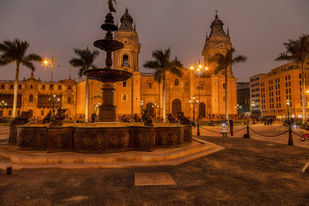 The main square - Plaza de Armas - with the Basilica Cathedral and the fountain in Lima, the capital of peru, at night. stock photo