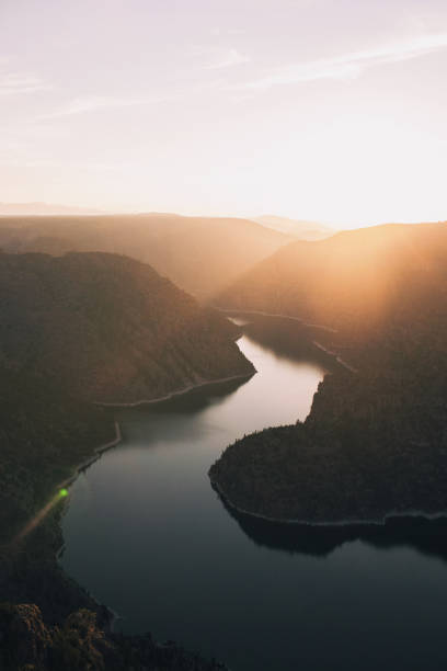 istock Mesmerizing view of a river surrounded by hills at scenic sunset 1455540925